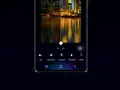 Interfaccia di editing foto su smartphone, con un paesaggio urbano notturno diviso a metà. L'opzione "galaxy enhance-x" migliora la nitidezza e i colori.