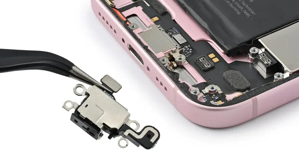Pinzette rimuovono il connettore di ricarica da un iPhone rosa aperto. Il touch screen iPhone non funziona in parte, forse per questo componente.