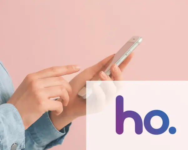 Mani che usano uno smartphone con il logo ho. in sovrimpressione, per scoprire la copertura 5G ho mobile.