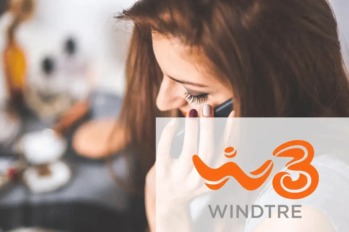 Woman on phone with WINDTRE logo.